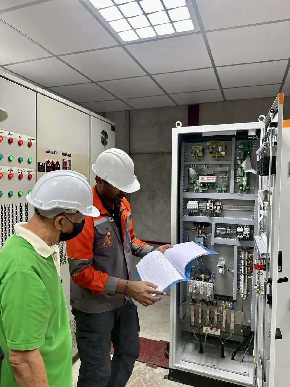Arrow Energy engineer checking the ESP T/R controller against the wiring schematic at commissioning
